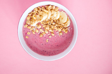 smoothie bowl cereal and banana pink background