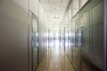 Empty corridor in modern factory. Hi-tech industrial interior in glass and steel