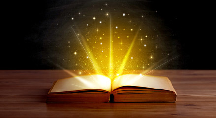 Yellow lights and sparkles coming from an open book 