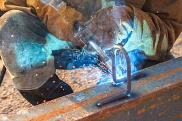 Worker welding in a factory. Welding on an industrial plant.