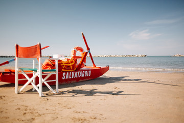 Lifeguard boat moored on the beach. Paddle boat with the written "Rescue" (Salvataggio). Gateo a Mare, Italy