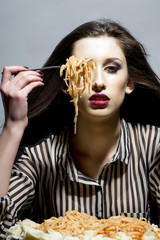 Pretty sexy girl with kitchen spaghetti pasta