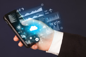 Hand using phone with cloud technology and linked information concept