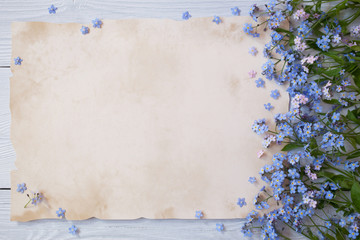 A bouquet of forget-me-nots and congratulatory paper, letters