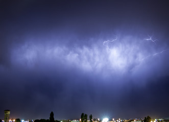 Lightning flash over a city, Thunderstorm , electricity blast storm