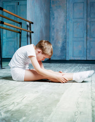 boy ballet dancer doing exercise at  dance class