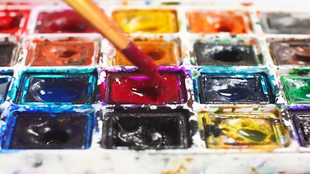 Artist brush mix color oil painting on palette close up.