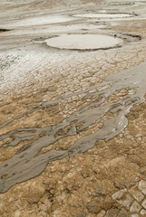 Fototapeta na wymiar mud volcanoes ponds and mud stream looking like lunar landscape in vulcanii noroiosi reserve paclele mari buzau county romania