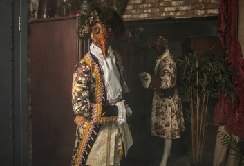Actors in steam punk masks and antique costumes indoor.
