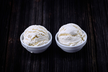 Vanilla ice cream with bowl on wooden background