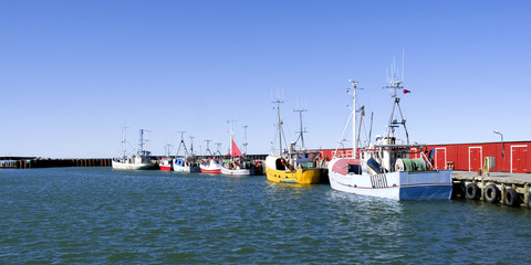Laesoe / Denmark: Fishing cutters moored in a row at the pier in the small fishing port of Oesterby Havn in April © torstengrieger