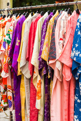 Sale of colorful kimonos on the city street in Kyoto, Japan. Close-up. Vertical.