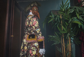 Actor in steam punk masks and antique costumes indoor.