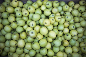 Green apple in wooden box on market for sale