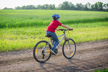 Obraz premium boy ride on bike at rural road