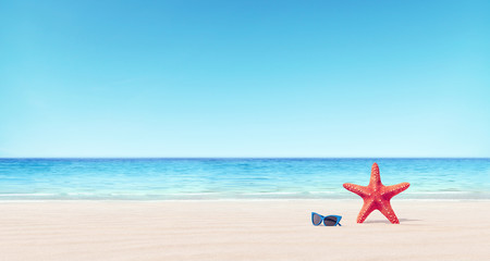 Red starfish and blue sunglasses on the beach summer background 3D Rendering