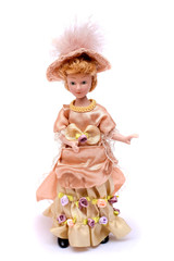 Porcelain doll in vintage dress and hat