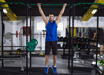 man doing pull ups on the horizontal bar - Powered by Adobe
