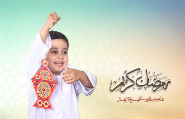 Ramadan Kareem - Happy young kid playing with Ramadan lantern - with islamic background with Pattern