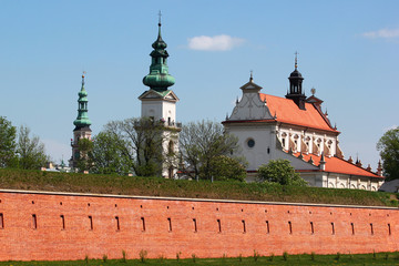 The Cathedral and theTown Hall behind red brick walls of old Zamosc fortress, Poland