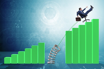 Business people jumping over bar charts