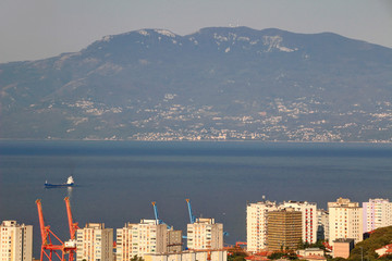 Waters of Kvarner Gulf in Adriatic Sea among port facilities, socialist tower blocks of Rijeka...
