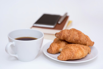 black coffee and fresh baked croissants