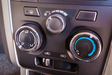 Detail of the air conditioning button control inside a car.