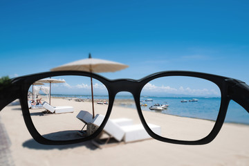 Summer holiday and vacation. Looking through sunglasses lens to beautiful beach in summer