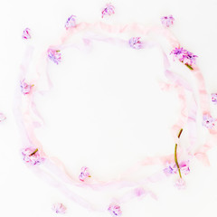 Purple frame made of pink hyacinth flowers and pastel tapes on white background. Flat lay, top view.
