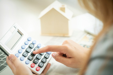 Woman accountant or bank worker uses calculator.