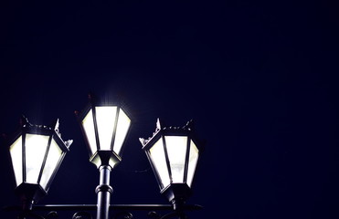 Cylindrical lamps in the night. Closeup. Copy space.