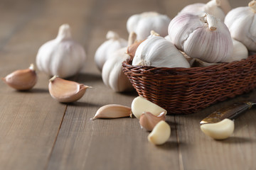 Garlic on bamboo basket on wood