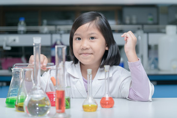 Happy little scientist making experiment