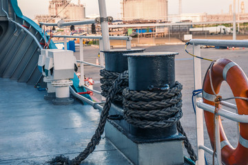 mooring equipment of ship. Mooring lines are fast on bollards, vessel is secured properly. All...