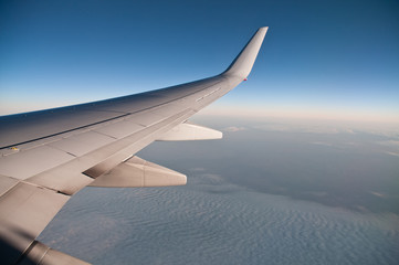 Fototapeta na wymiar Cloudy scene from aeroplane window view