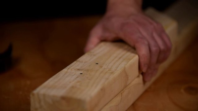 Hammering a nail into fresh lumber in a single hit