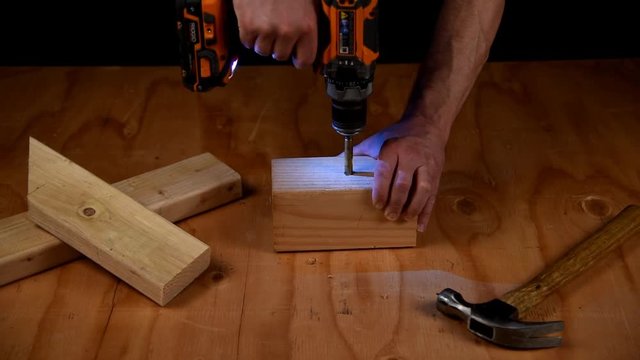 Drilling a three quarter inch hole in a square block of lumber