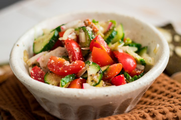 Fresh vegetables Greek salad with tomatoes, cucumbers, onion slices and sprouts. Served with olive oil. Raw vegan vegetarian healthy food on lunch or dinner