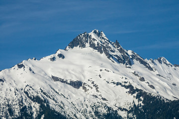 Fototapeta na wymiar majestic mountain peak covered with snow under the blue sky in a sunny day