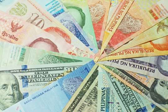Bitcoin stack on multi national banknote bill background, bitcoin concept, dollar, baht, ringit, peso
