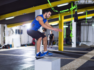 man working out jumping on fit box