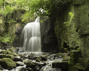 Lumsdale Falls, Derbyshire.  A tranquil setting under a green canopy shading the gentle flow of the Bentley Brook.