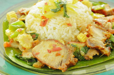 spicy stir fried sweet grilled and crispy pork with basil leaf on rice
