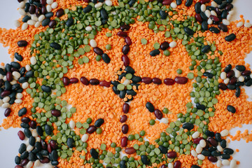 Food mandala with red kidney Beans, white Beans, black Beans, green Peas, red Lentils. Flat lay made of food ingredients: pea, lentils, bean.