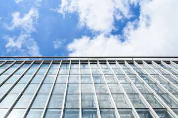 Modern Architecture high-rise building raising to the sky. Facade glass window. sky background