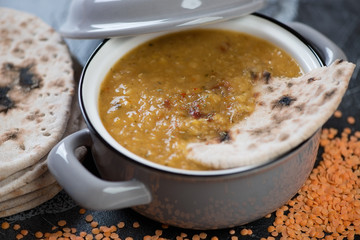 Close-up of a pan with thick indian red lentil soup, selective focus, horizontal shot