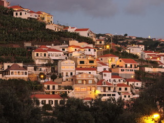 Hillside houses with red roofs in the evening, Madeira