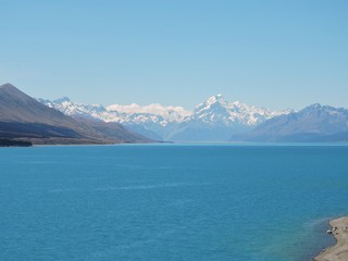 View on snow-capped mountains from stunning blue Lake Pukaki, New Zealand, Aoraki / Mount Cook
