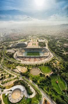 Barcelona aerial view, Anella Olimpica sport complex on the hill with city skyline , Spain. Sunbeam light